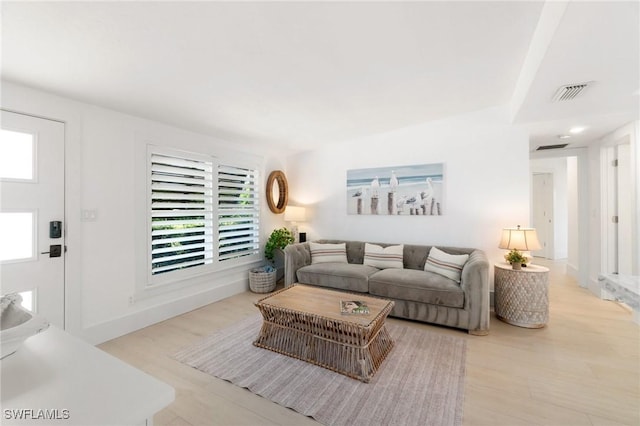 living room featuring wood finished floors and visible vents