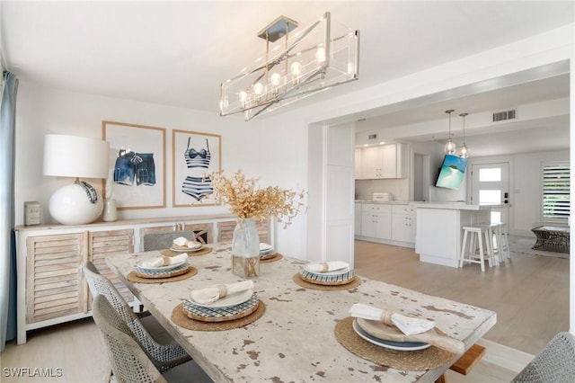 dining space with visible vents and light wood-style floors