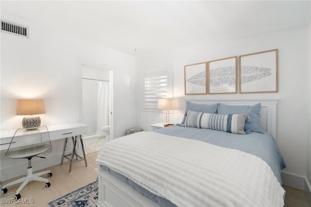 bedroom featuring visible vents and ensuite bathroom