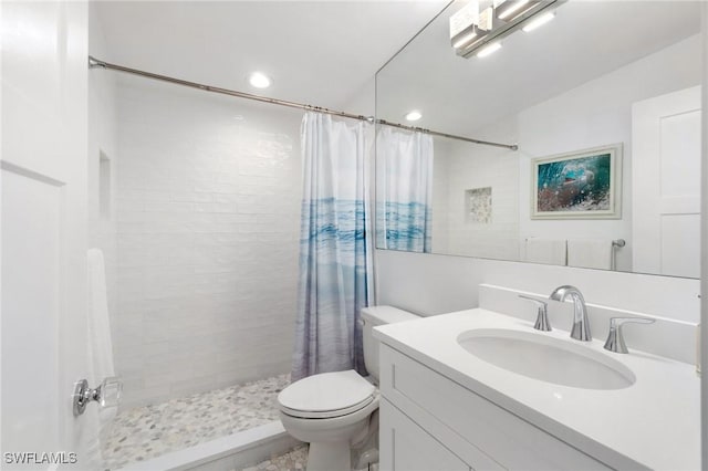 full bathroom with recessed lighting, toilet, vanity, and a tile shower