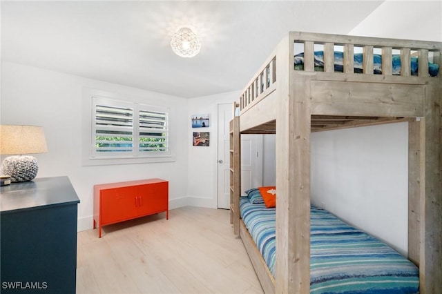 bedroom with baseboards and wood finished floors