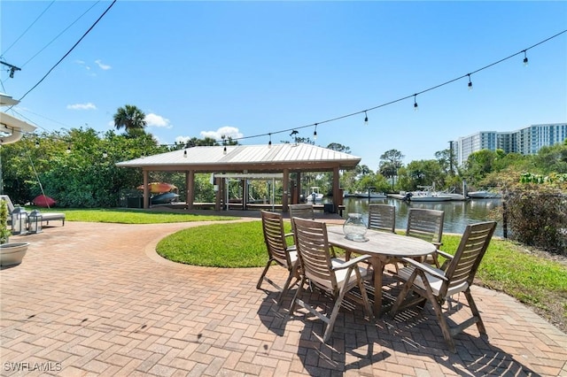 view of patio featuring outdoor dining space, a gazebo, and a water view