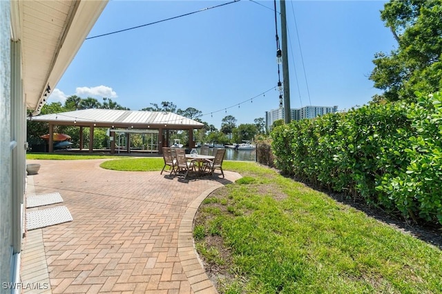 exterior space featuring a gazebo, a patio area, and a lawn