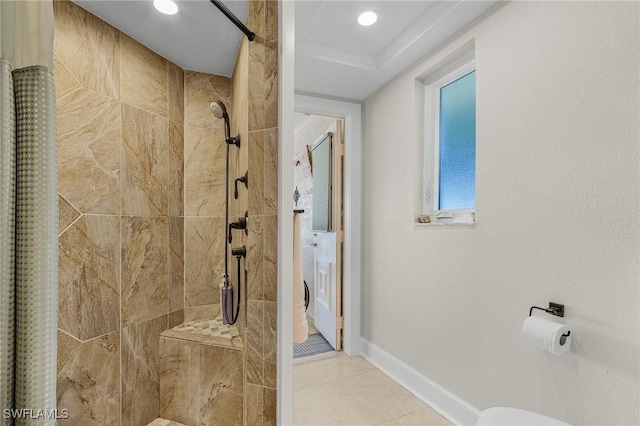 full bath with tile patterned floors, baseboards, and tiled shower