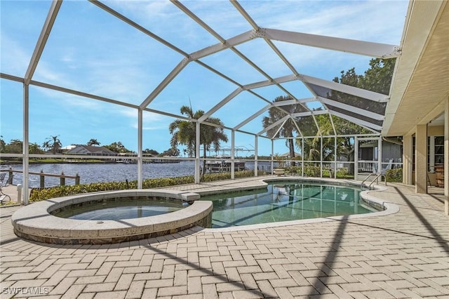 view of swimming pool featuring glass enclosure, a pool with connected hot tub, a patio, and a water view