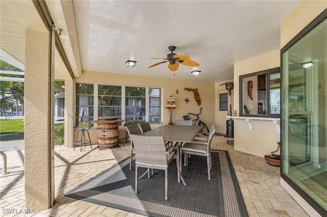 sunroom with a healthy amount of sunlight and a ceiling fan