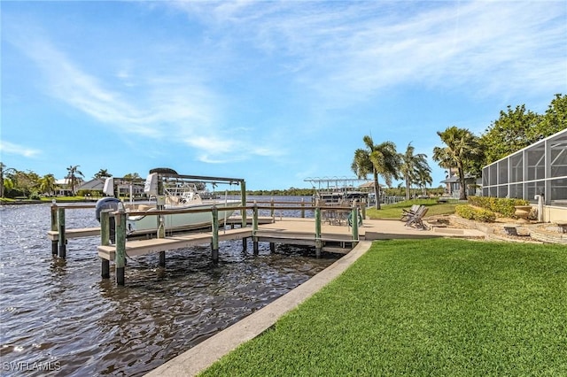 dock area with a yard, a water view, and boat lift