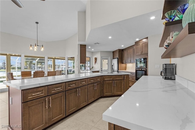 kitchen with pendant lighting, light tile patterned floors, recessed lighting, dobule oven black, and open shelves