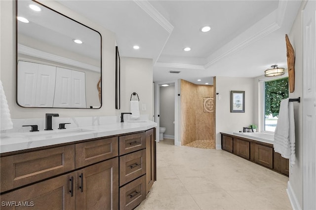 bathroom with toilet, ornamental molding, tiled shower, a bath, and a sink