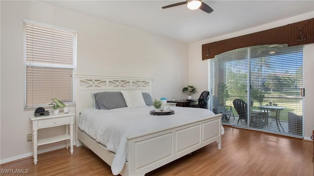 bedroom with baseboards, light wood-style floors, ceiling fan, and access to outside