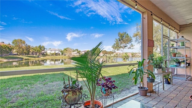 unfurnished sunroom with a water view