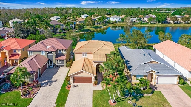 drone / aerial view featuring a residential view and a water view