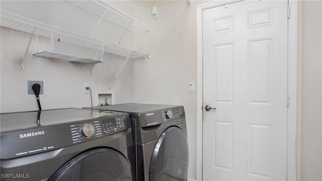 clothes washing area featuring washing machine and clothes dryer and laundry area