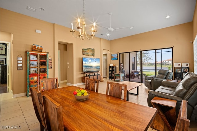 dining area featuring baseboards, visible vents, a chandelier, and light tile patterned flooring