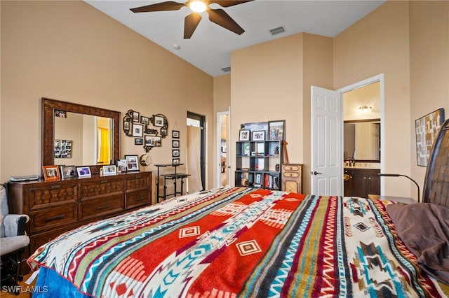 bedroom featuring a towering ceiling, ceiling fan, visible vents, and connected bathroom