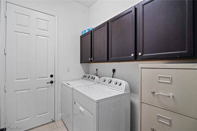 laundry area featuring cabinet space, washing machine and clothes dryer, and light tile patterned floors