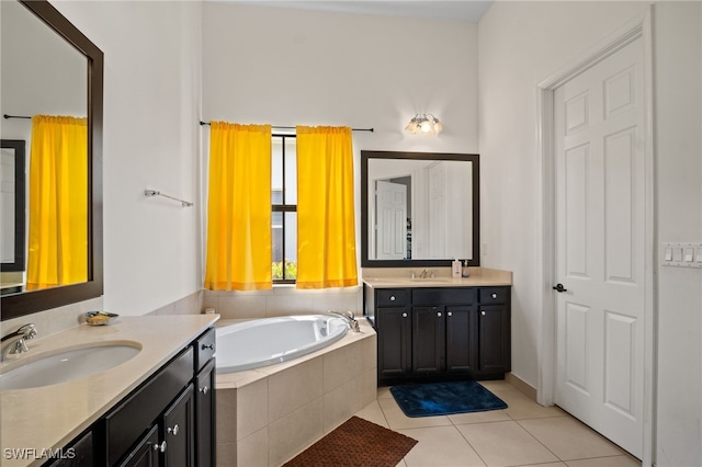 full bath with a garden tub, two vanities, a sink, and tile patterned floors