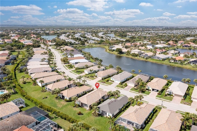 drone / aerial view with a residential view and a water view