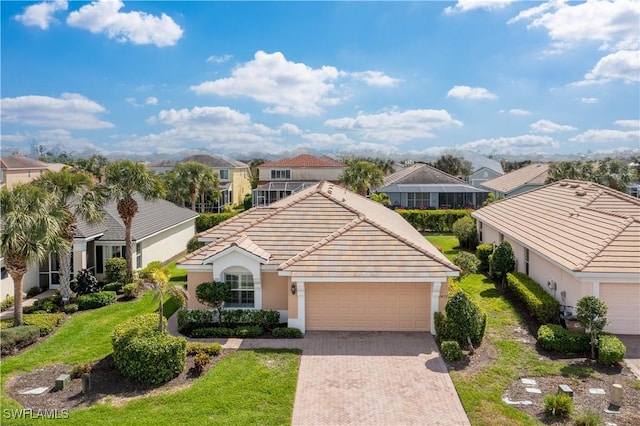 view of front facade featuring a residential view, a tile roof, stucco siding, decorative driveway, and a garage