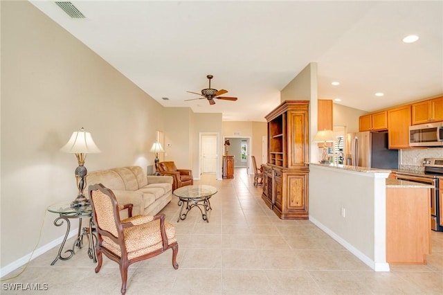 living room featuring light tile patterned flooring, visible vents, recessed lighting, and a ceiling fan