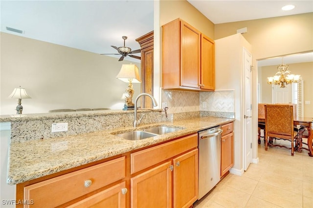 kitchen with visible vents, a sink, decorative backsplash, light stone countertops, and dishwasher