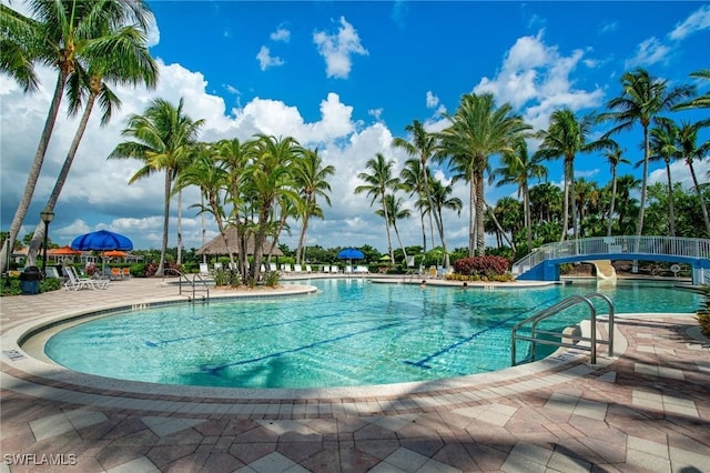 community pool featuring fence and a patio area