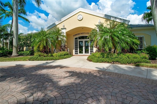 exterior space with french doors and stucco siding