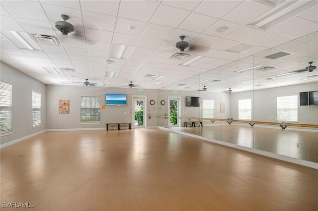 miscellaneous room featuring a drop ceiling, visible vents, baseboards, and ceiling fan