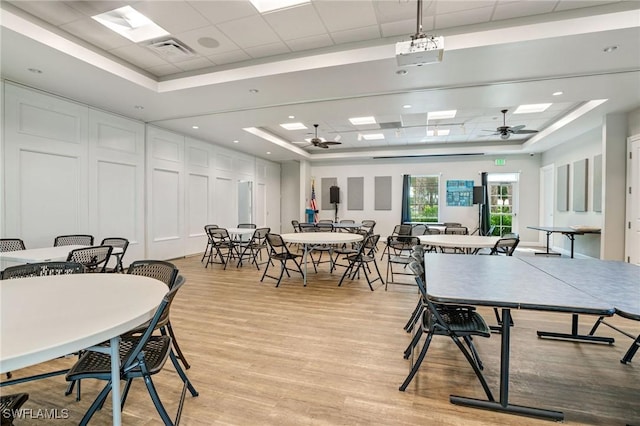 dining room featuring visible vents, ceiling fan, and a tray ceiling