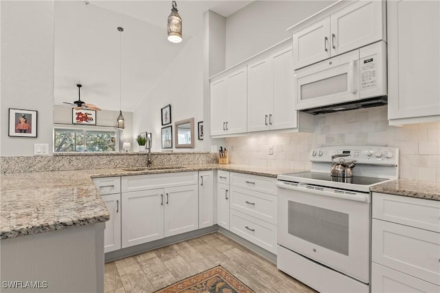 kitchen with decorative light fixtures, white appliances, backsplash, and white cabinets