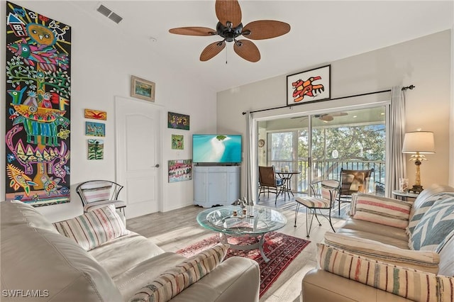 living area featuring visible vents, wood finished floors, ceiling fan, and vaulted ceiling