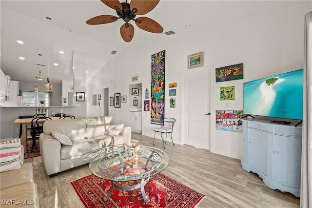 living room featuring visible vents, light wood-style flooring, recessed lighting, lofted ceiling, and ceiling fan