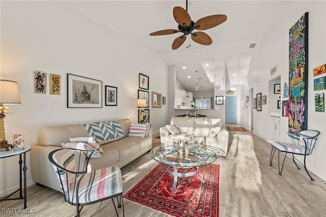 living room with visible vents, lofted ceiling, recessed lighting, ceiling fan, and light wood-type flooring