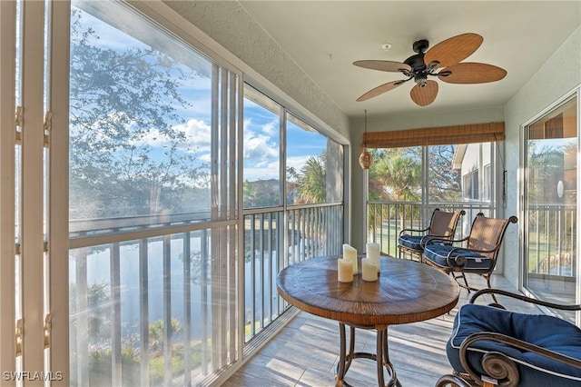 sunroom featuring a ceiling fan