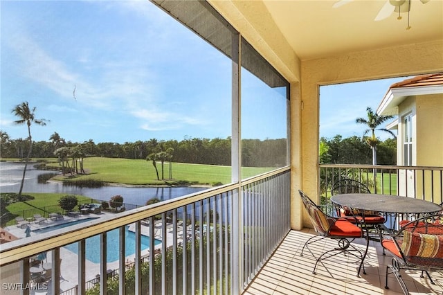 balcony with a water view and ceiling fan