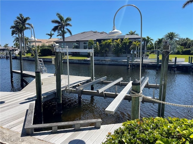 view of dock with boat lift and a water view