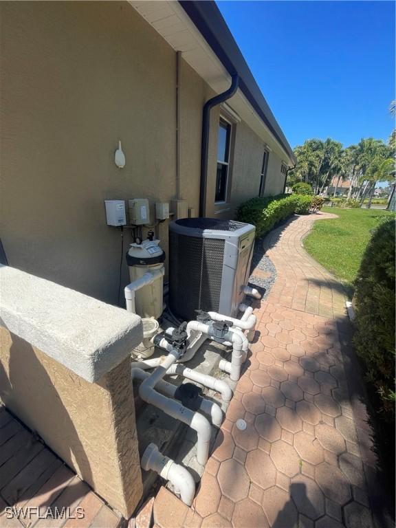 2016 El Dorado Pkwy W, Cape Coral, FL 33914 - view of side of property with central air condition unit and stucco siding
