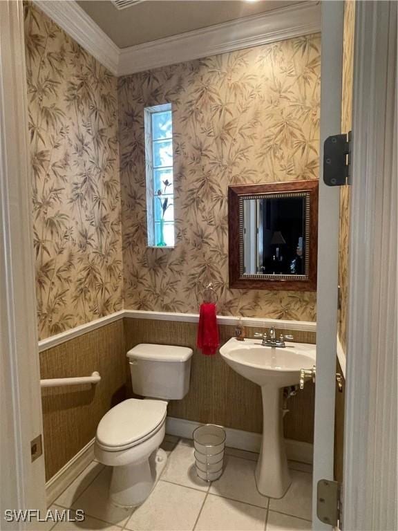 2016 El Dorado Pkwy W, Cape Coral, FL 33914 - half bath with tile patterned floors, a wainscoted wall, toilet, ornamental molding, and wallpapered walls