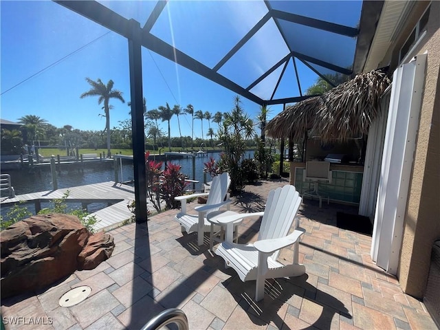 2016 El Dorado Pkwy W, Cape Coral, FL 33914 - view of patio with area for grilling, glass enclosure, a boat dock, and a water view