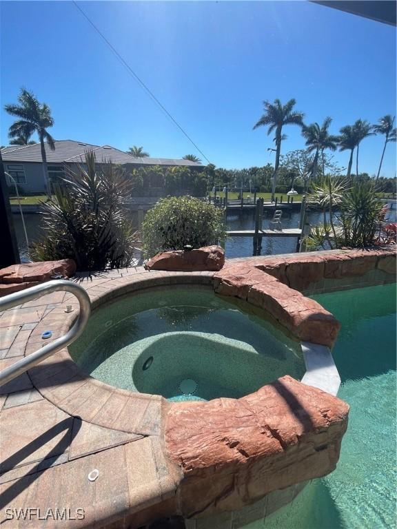 2016 El Dorado Pkwy W, Cape Coral, FL 33914 - view of swimming pool featuring a pool with connected hot tub and a dock