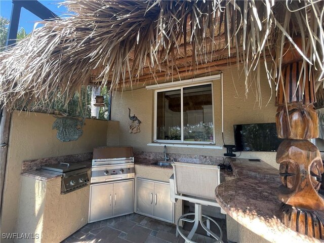 2016 El Dorado Pkwy W, Cape Coral, FL 33914 - view of patio / terrace with a sink, grilling area, and an outdoor kitchen