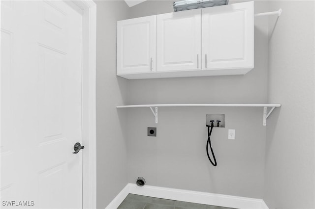 washroom with electric dryer hookup, baseboards, cabinet space, and hookup for a washing machine