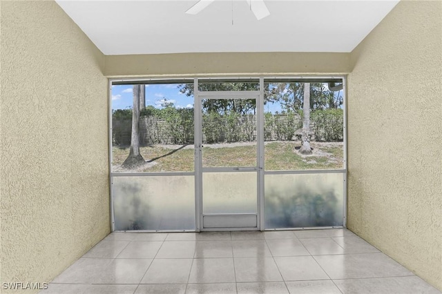 unfurnished sunroom with ceiling fan