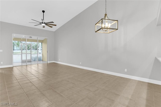 empty room with light tile patterned floors, ceiling fan with notable chandelier, baseboards, and lofted ceiling