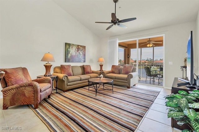 living room with ceiling fan, light tile patterned flooring, and vaulted ceiling