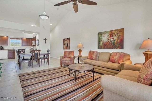 living area with high vaulted ceiling and a ceiling fan