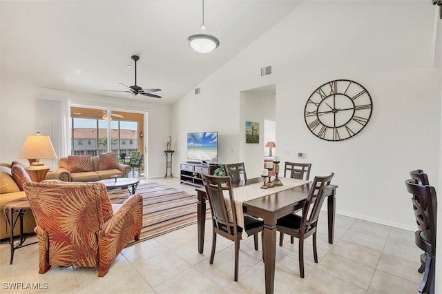 dining area featuring ceiling fan, visible vents, high vaulted ceiling, and light tile patterned flooring