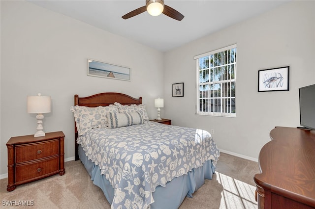 carpeted bedroom with baseboards and ceiling fan