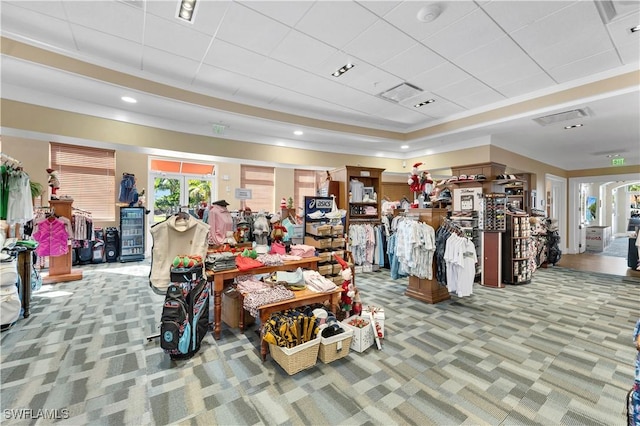 misc room with a raised ceiling, carpet, and visible vents