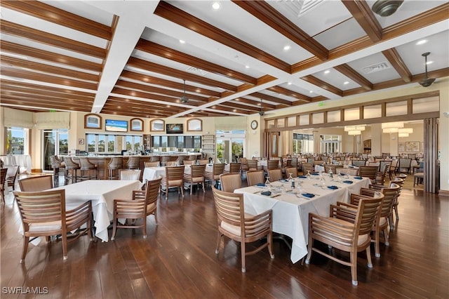 dining space with hardwood / wood-style flooring, visible vents, and beam ceiling